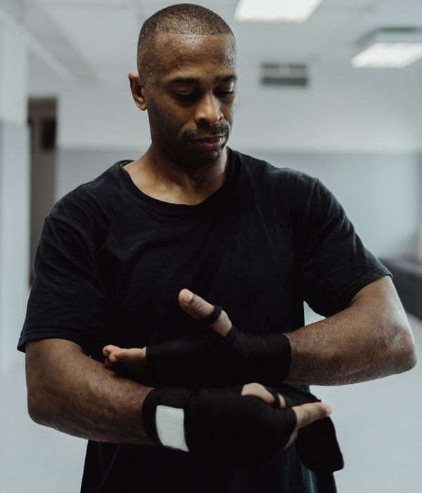 Athletic man in a focused pose, ready for a strength workout.